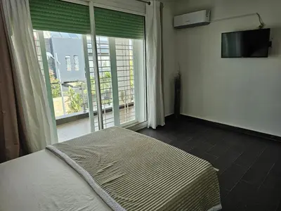 a bedroom with a bed and a large window at Villa in Fès