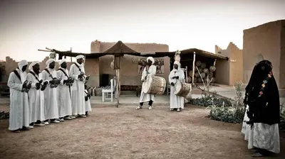 a group of nuns standing in front of a building at Authentic Sahara Desert Camps in Merzouga