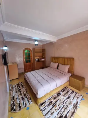 a bedroom with a large bed and a rug at Dar Fatna Marrakech in Oulad Akkou
