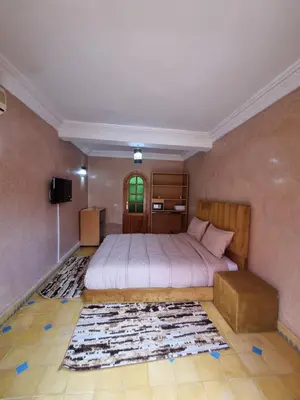 a bedroom with a bed in a room with a rug at Dar Fatna Marrakech in Oulad Akkou