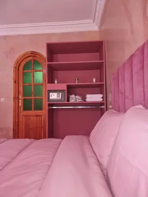 a bedroom with two beds and a window at Dar Fatna Marrakech in Oulad Akkou