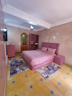 a bedroom with a large pink bed in a room at Dar Fatna Marrakech in Oulad Akkou