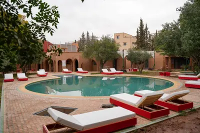 a swimming pool with lounge chairs and a resort at Dar Fatna Marrakech in Oulad Akkou