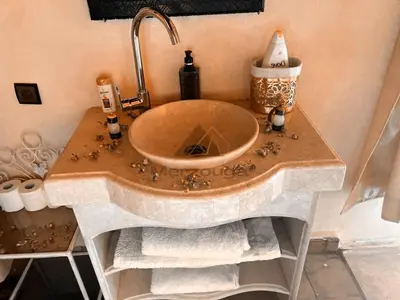 a bathroom with a sink with a counter top at Merzouga Luxurious Sahara Camps in Merzouga