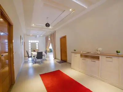 a kitchen with a red rug on the floor at Villa privée & élégante avec piscine & jardin in Marrakech