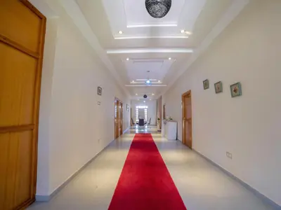 a long hallway with a red carpet on the floor at Villa privée & élégante avec piscine & jardin in Marrakech