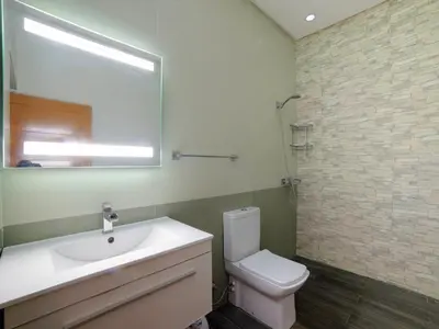a bathroom with a toilet and a sink and a mirror at Villa privée & élégante avec piscine & jardin in Marrakech