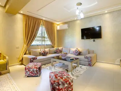 a living room with a couch and a table at Villa privée & élégante avec piscine & jardin in Marrakech