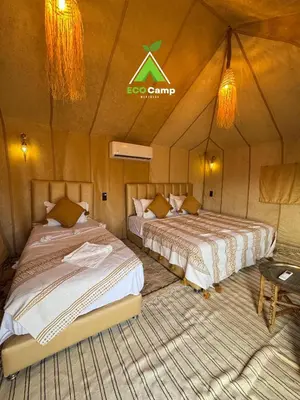 a room with two beds in a tent at Eco Desert Camp in Merzouga