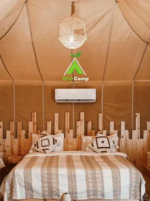 a bedroom with a bed in a tent at Eco Desert Camp in Merzouga