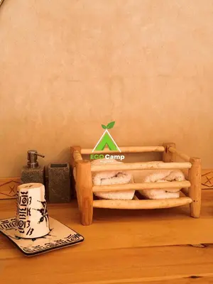 a display of breads in a wooden tray on a table at Eco Desert Camp in Merzouga