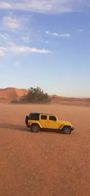 a yellow truck in the middle of the desert at Sahara 4Seasons Appartement in Merzouga