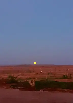 a sunset in the middle of the desert at Sahara 4Seasons Appartement in Merzouga