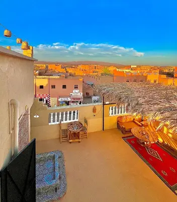 an apartment balcony with a view of a city at Riad Dar Sahara - Panoramic Rooftop in Nkob