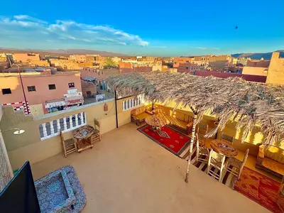a balcony of a building with a view of a city at Riad Dar Sahara - Panoramic Rooftop in Nkob