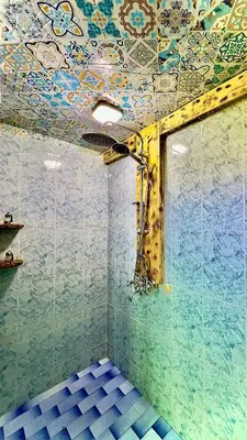 a room with a ceiling covered in colorful tiles at Riad Dar Sahara - Panoramic Rooftop in Nkob