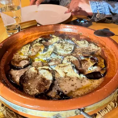 a bowl of food sitting on a table at Aurea Duna Luxury Camp in Merzouga