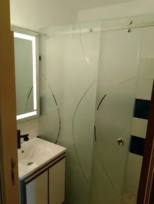 a bathroom with a shower and a sink at Appartement lux in Fès