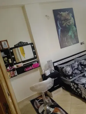 a room with a bed and a desk with a mirror at Appartement lux in Fès