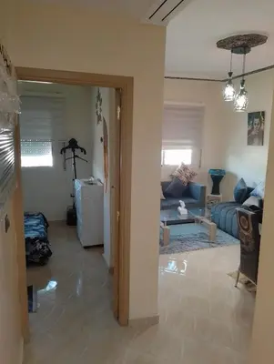 a living room with a couch and a table at Appartement lux in Fès