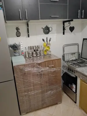 a kitchen with a counter with plastic wrap on it at Appartement lux in Fès