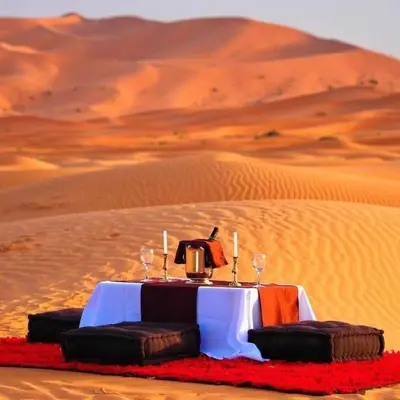 a table in the middle of the desert at Spectacular Luxury Camp in Merzouga