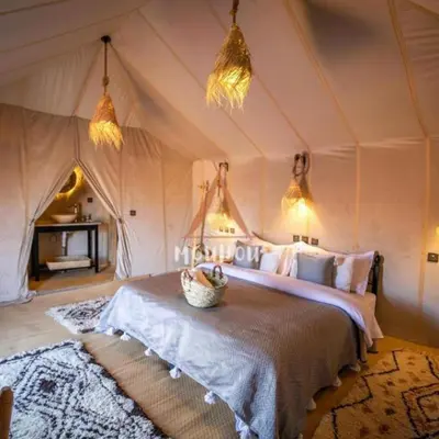 a bedroom with a bed in a tent at Spectacular Luxury Camp in Merzouga