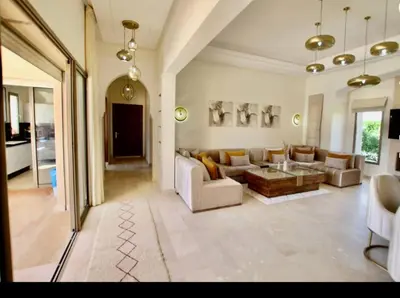 a large living room with a couch and a table at Sublime Villa Piscine & Jacuzzi in Marrakech