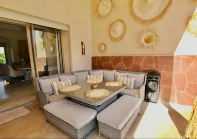 a living room with a table and a couch at Sublime Villa Piscine & Jacuzzi in Marrakech