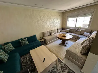a living room with a couch and a table at Tigemi in Fès