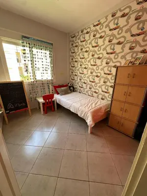 a bedroom with a bed and a wall with penguins at Tigemi in Fès