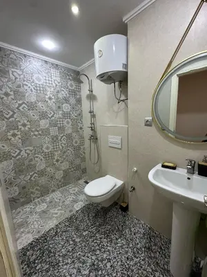 a bathroom with a toilet and a sink and a mirror at Tigemi in Fès