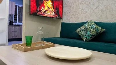 a living room with a green couch and a table at Tigemi in Fès