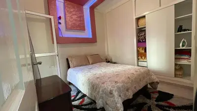 a small bedroom with a bed and a dresser at Tigemi in Fès