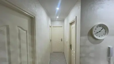 a hallway with a clock on the wall at Tigemi in Fès