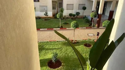 a view of a courtyard with trees and plants at Tigemi in Fès