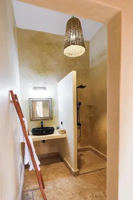 a bathroom with a sink and a mirror at Dar des gazelles kech in Oulad Abbou