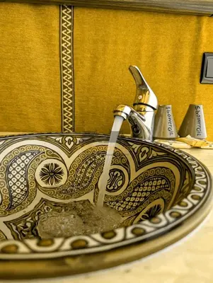 a sink with a faucet in a bathroom at Merzouga Chic Luxury Camps in Merzouga