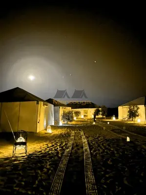 a train track in the desert at night at Merzouga Chic Luxury Camps in Merzouga