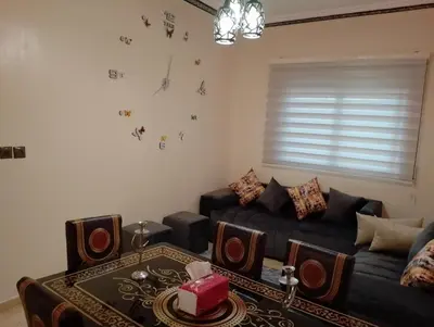 a living room with a couch and a table at Appartement Fadila in Fès