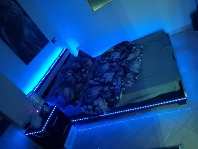 a bed with a blue light in a room at Appartement Fadila in Fès