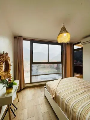 a bedroom with a bed and a large window at Dar Itri in Ourika