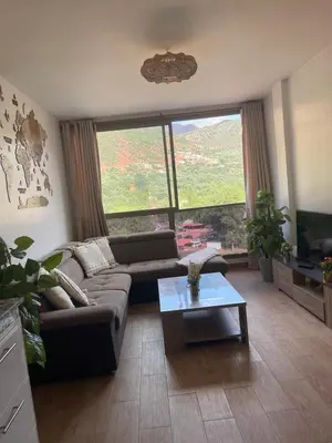 a living room with a couch and a table at Dar Itri in Ourika