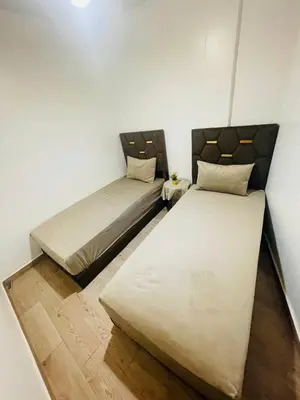 two beds in a small room withermottermottermott at Dar Itri in Ourika