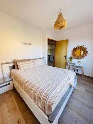a bedroom with a large bed and a mirror at Dar Itri in Ourika