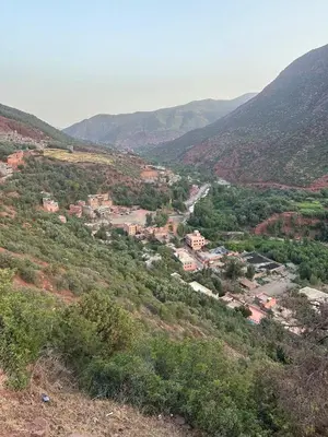 a view of a town in a valley with mountains at Dar Itri in Ourika