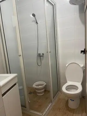 a bathroom with a shower with a toilet and a glass shower stall at Dar Itri in Ourika