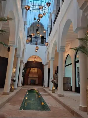 a lobby with a pool in the middle of a building at Palm View Palace in Ouarzazate