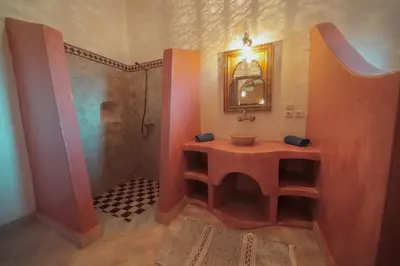 a bathroom with a shower and a sink and a sink at Palm View Palace in Ouarzazate
