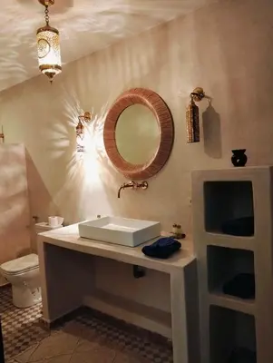 a bathroom with a sink and a mirror on the wall at Palm View Palace in Ouarzazate